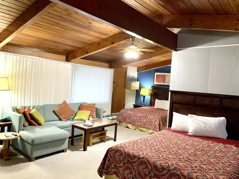 Family suite sitting area under a timber ceiling